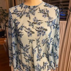 Light blue women’s blouse with bell sleeves.